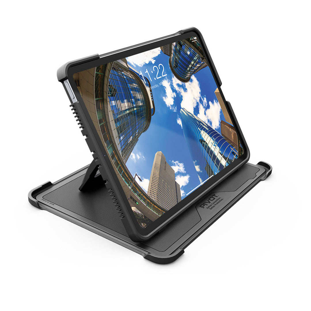 A PIVOT A20A encased in a rugged black protective cover stands on an adjustable kickstand. The tablet screen displays a cityscape with tall, modern buildings under a blue sky with clouds. The time shown on the screen is 11:22.