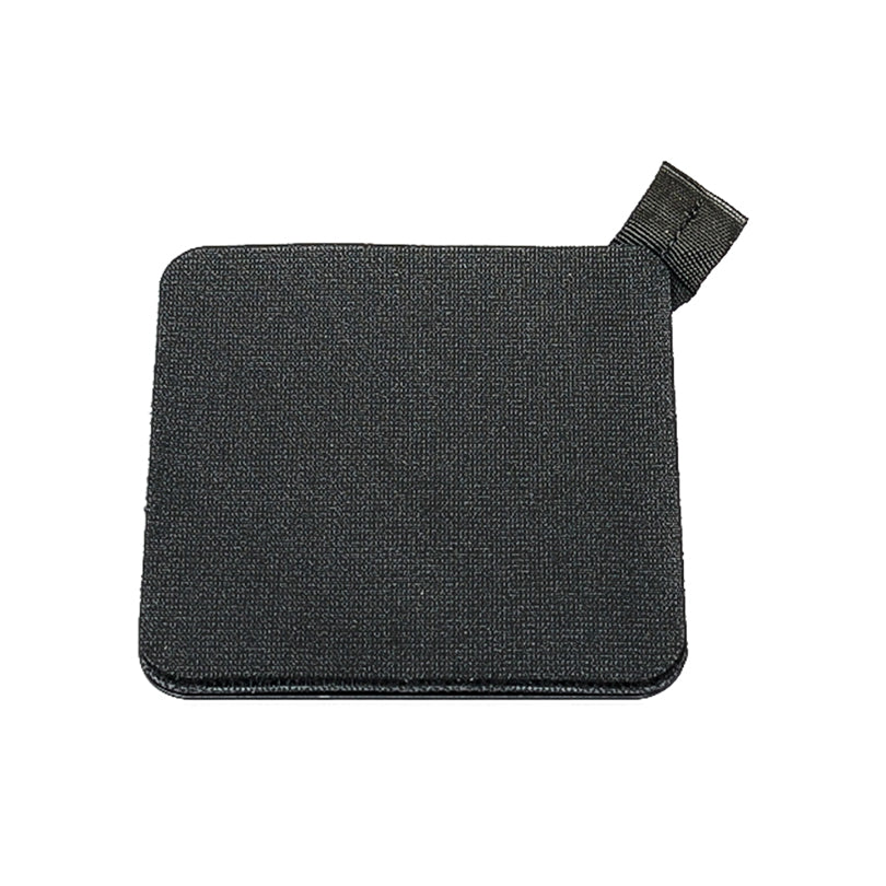 A small rectangular black patch with rounded corners and a fabric loop on one corner. The surface appears textured, akin to the Heavy Duty Velcro® Mount by PIVOT.