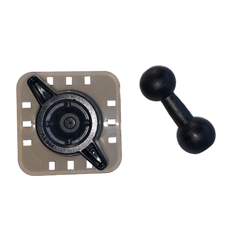 A square beige plastic piece with a black circular component in the center and several small rectangular holes around the edges is shown next to a black, dual-rounded knob resembling a small dumbbell. The product is the PPK-1 2.0 Mounting Plate by PIVOT.